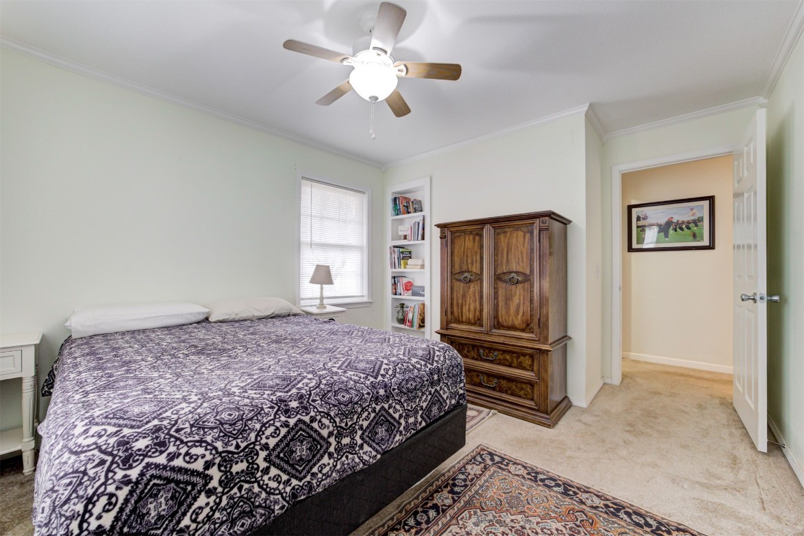 10774 S Pine Street, Guthrie, OK 73044 carpeted bedroom with crown molding and ceiling fan