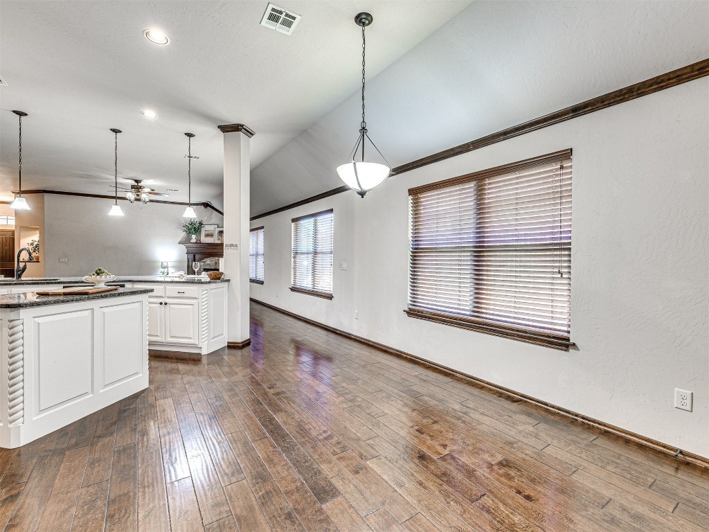 13512 Borgata Lane, Oklahoma City, OK 73170 kitchen featuring white cabinets, dark wood-type flooring, ceiling fan, and pendant lighting