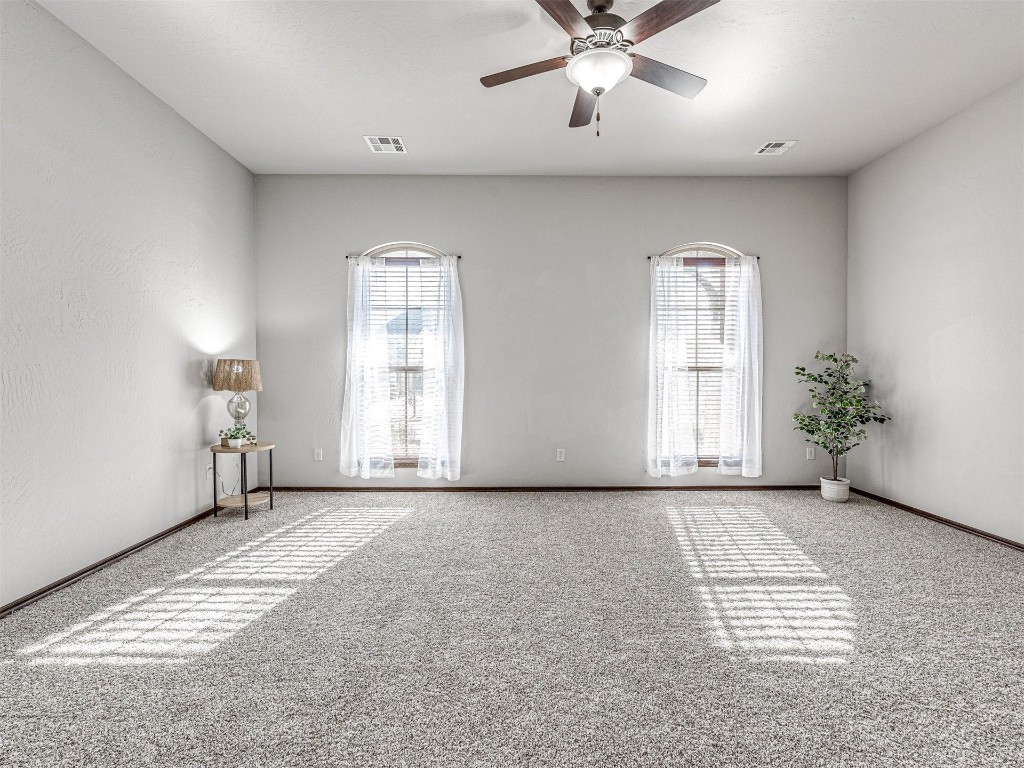 13512 Borgata Lane, Oklahoma City, OK 73170 unfurnished room with light colored carpet and ceiling fan