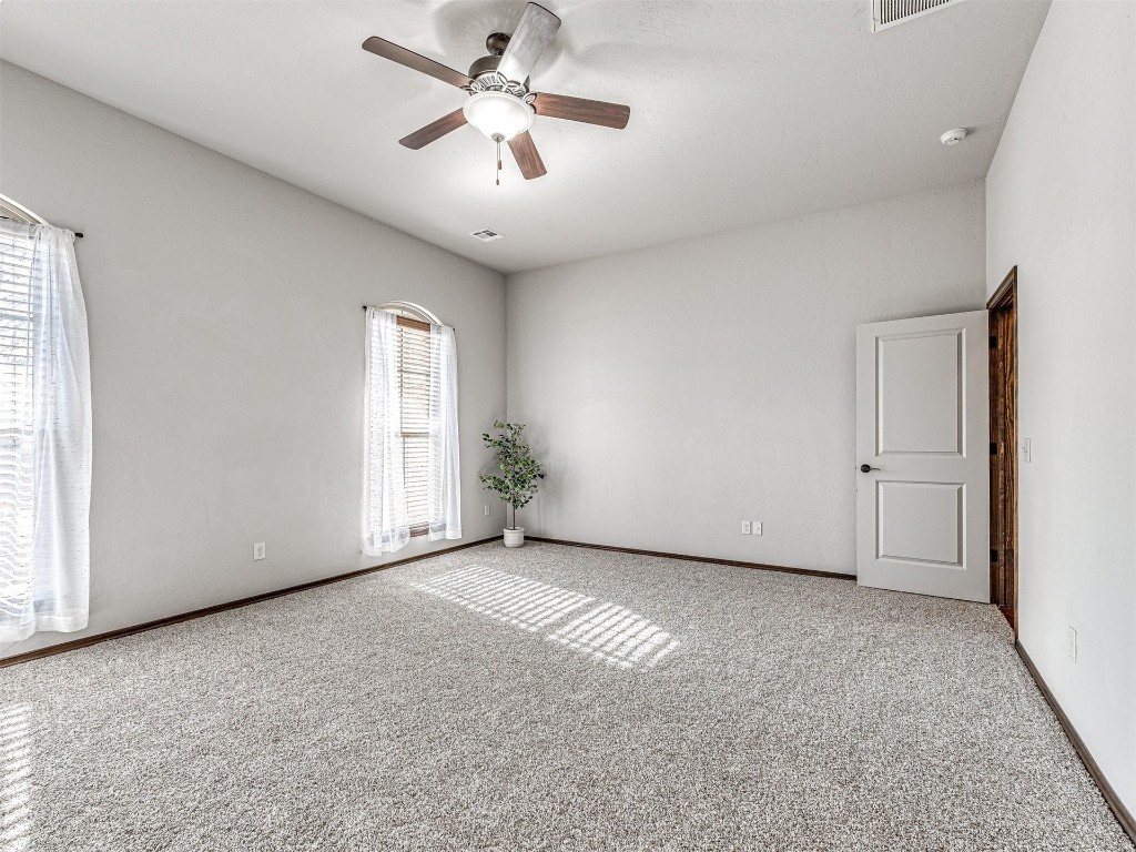 13512 Borgata Lane, Oklahoma City, OK 73170 empty room featuring light colored carpet and ceiling fan