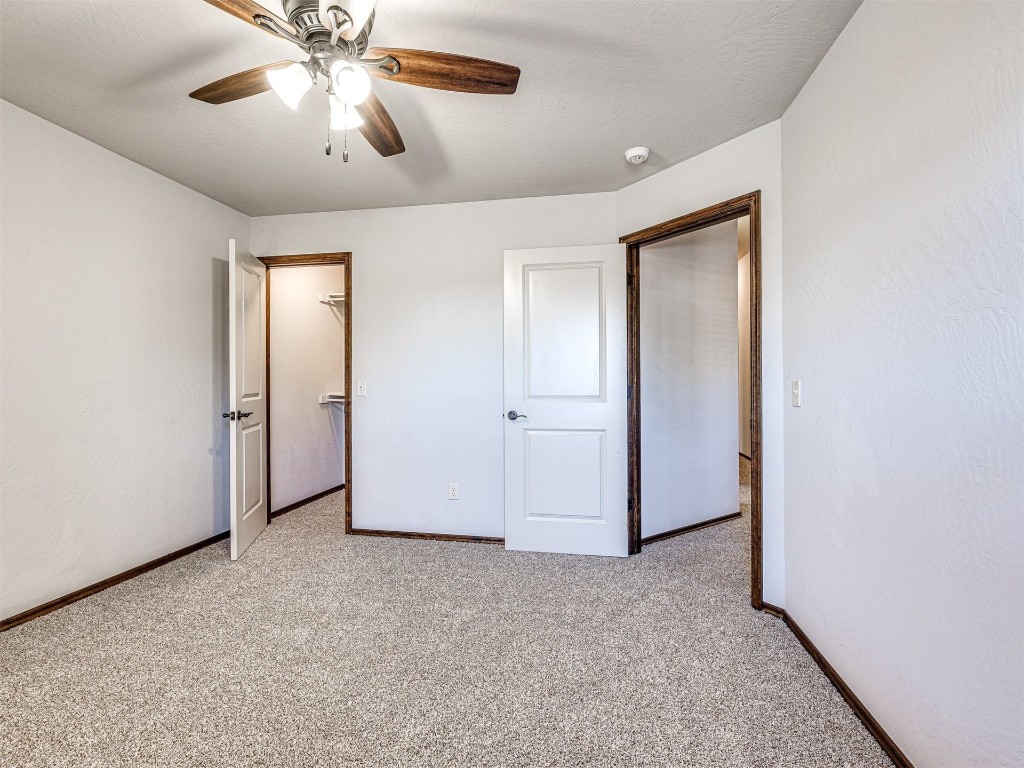 13512 Borgata Lane, Oklahoma City, OK 73170 unfurnished bedroom featuring a closet, light carpet, and ceiling fan