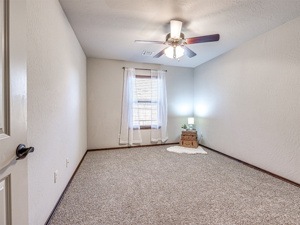 13512 Borgata Lane, Oklahoma City, OK 73170 carpeted empty room featuring a textured ceiling and ceiling fan