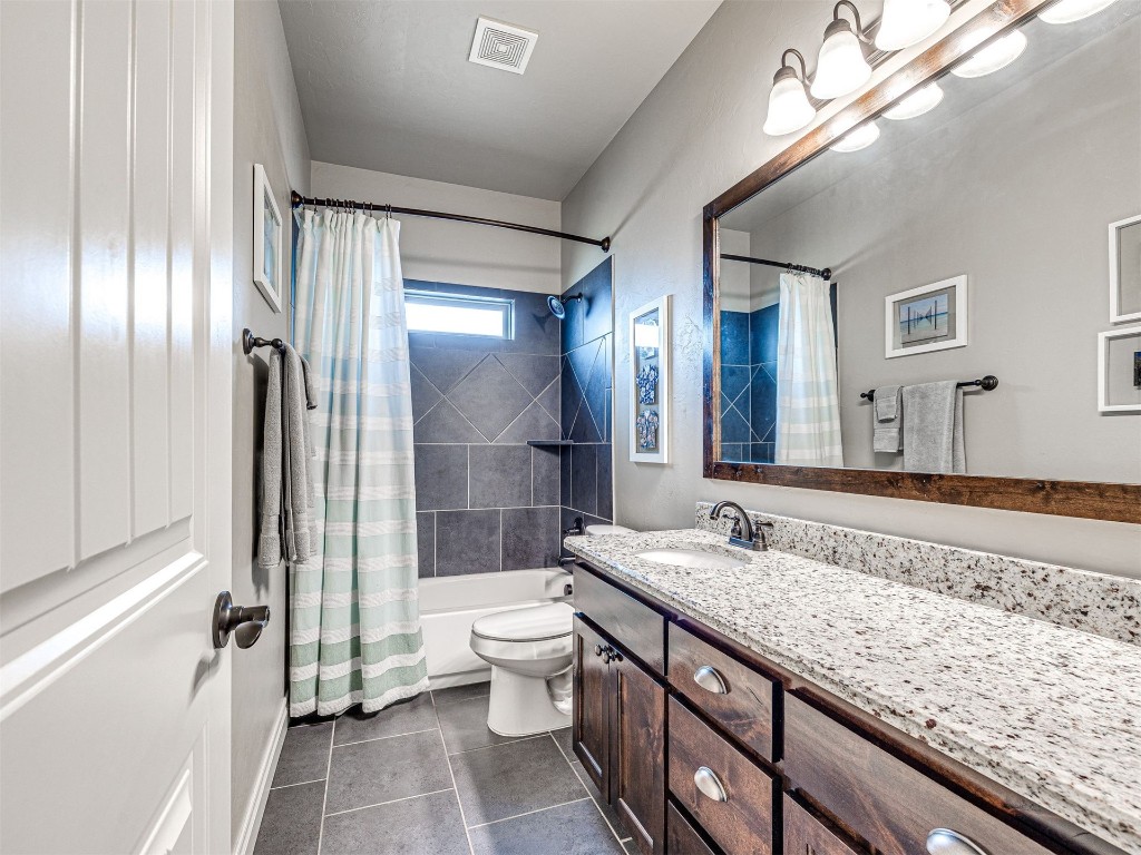 12600 SW 24th Street, Yukon, OK 73099 full bathroom with vanity, shower / tub combo, toilet, and tile flooring