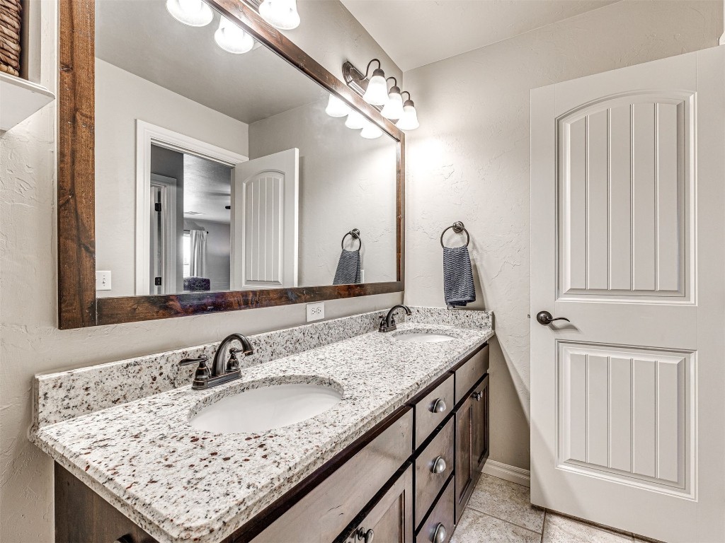 12600 SW 24th Street, Yukon, OK 73099 bathroom with tile floors, large vanity, and dual sinks