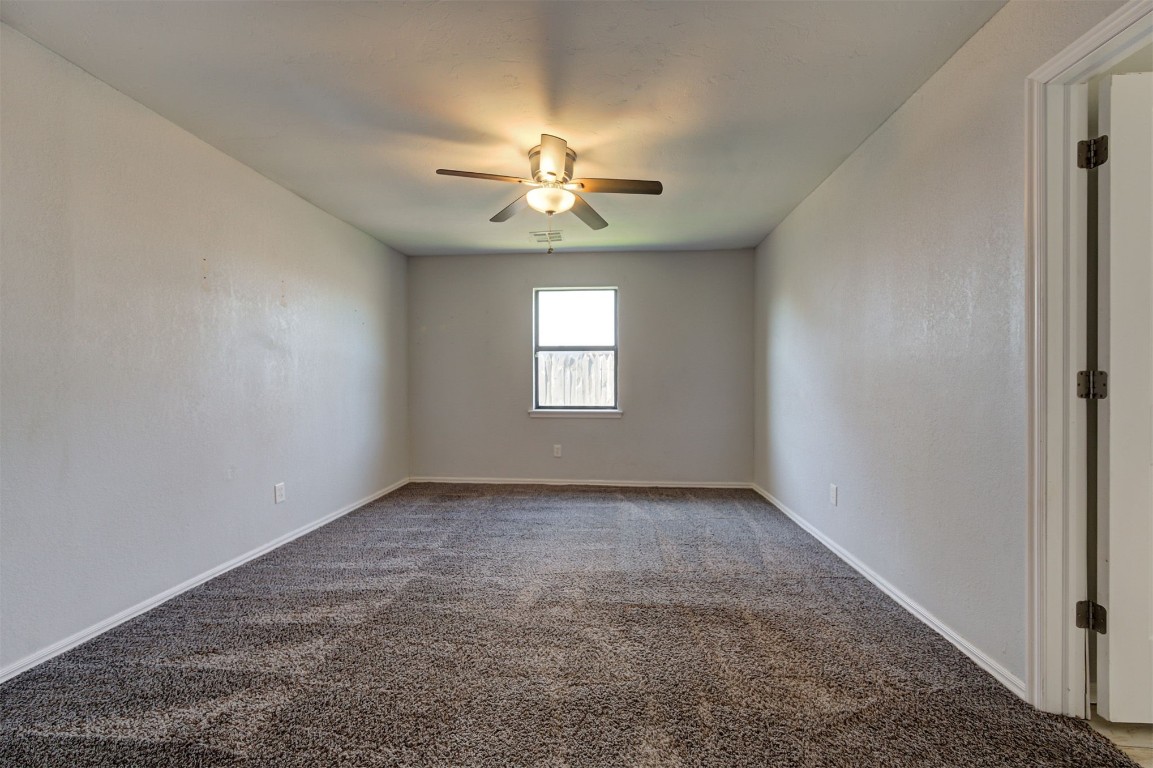 10101 Southridge Drive, Oklahoma City, OK 73159 unfurnished room with dark carpet and ceiling fan