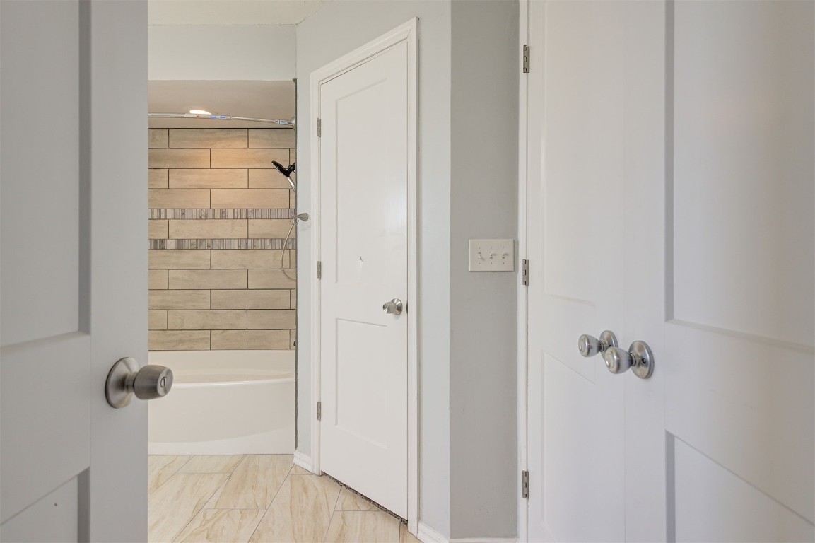 10101 Southridge Drive, Oklahoma City, OK 73159 bathroom with tiled shower / bath combo and tile flooring