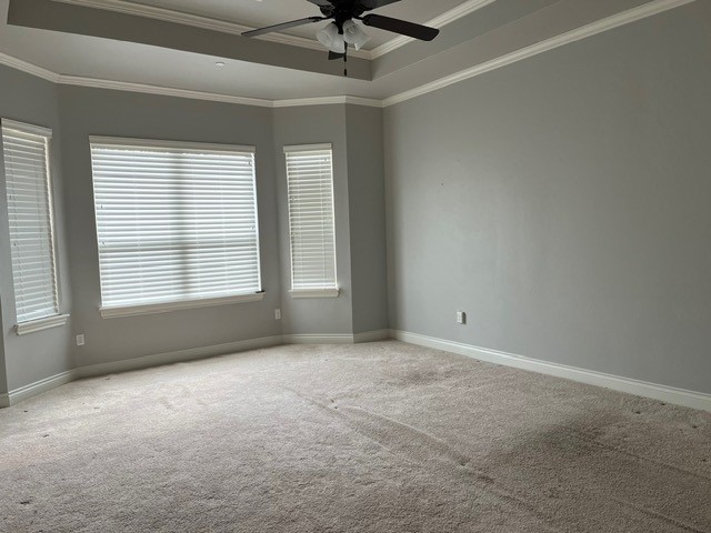5600 Montford Way, Choctaw, OK 73020 carpeted spare room featuring crown molding, ceiling fan, and a tray ceiling
