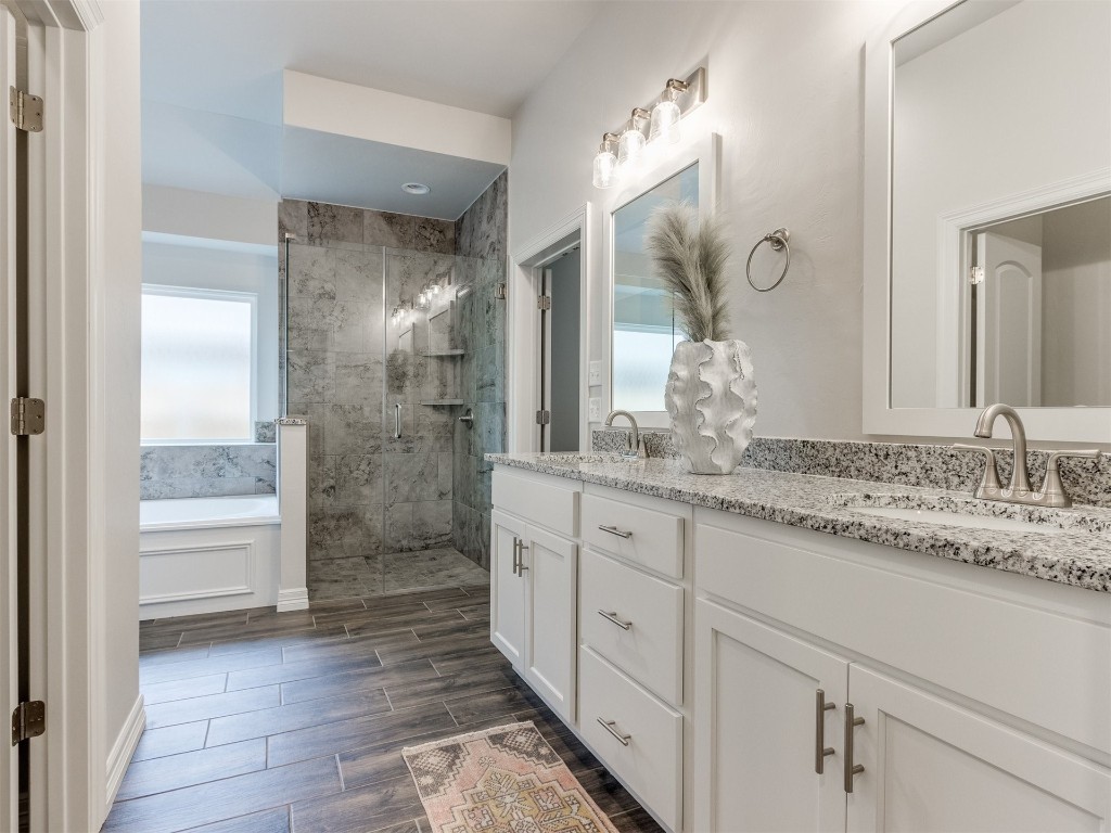 16200 Brenton Hills Avenue, Edmond, OK 73013 bathroom with dual bowl vanity and shower with separate bathtub