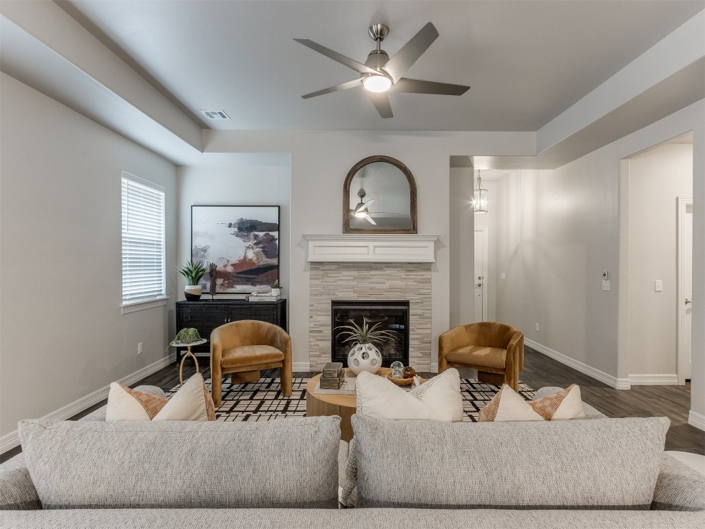 16200 Brenton Hills Avenue, Edmond, OK 73013 living room featuring a fireplace, dark hardwood / wood-style flooring, and ceiling fan