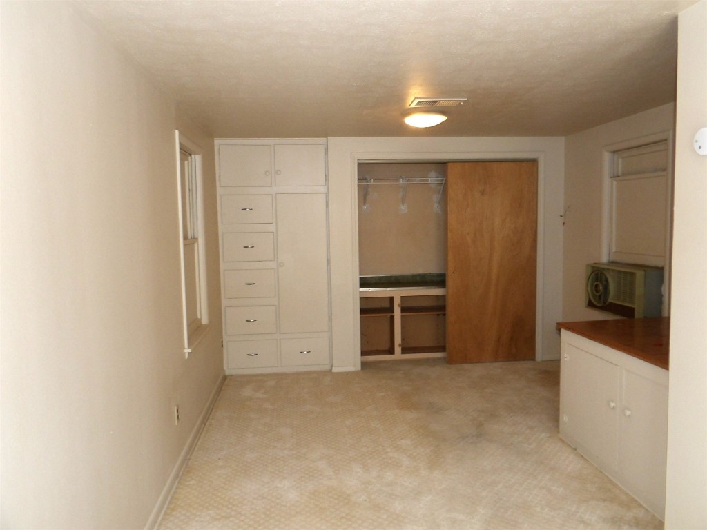 225 NW 1st Street, Moore, OK 73160 unfurnished bedroom featuring light colored carpet and a closet