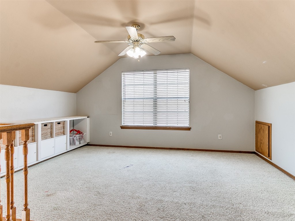 1013 SW 126th Street, Oklahoma City, OK 73170 additional living space featuring vaulted ceiling, ceiling fan, and light carpet