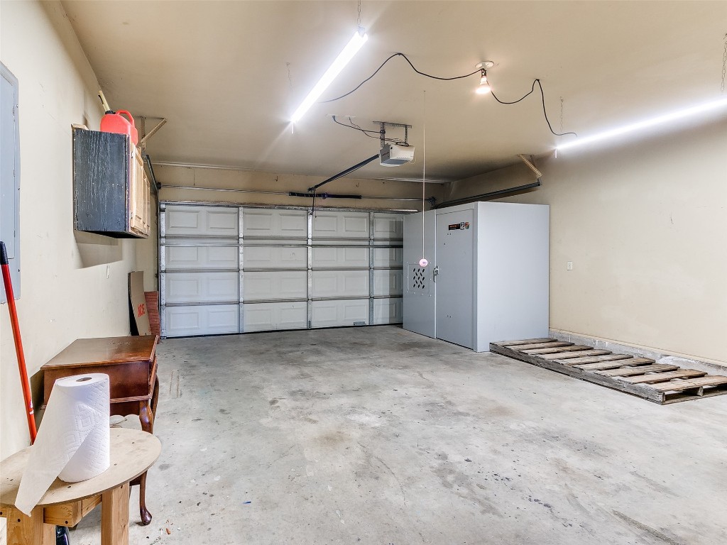 1013 SW 126th Street, Oklahoma City, OK 73170 garage featuring a garage door opener