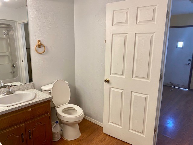 833 S Ellison Avenue, El Reno, OK 73036 bathroom featuring vanity, hardwood / wood-style flooring, and toilet