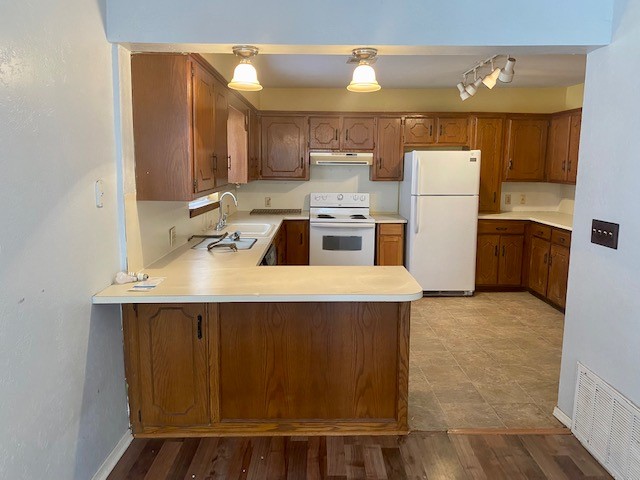 833 S Ellison Avenue, El Reno, OK 73036 kitchen with rail lighting, white appliances, sink, light tile flooring, and kitchen peninsula