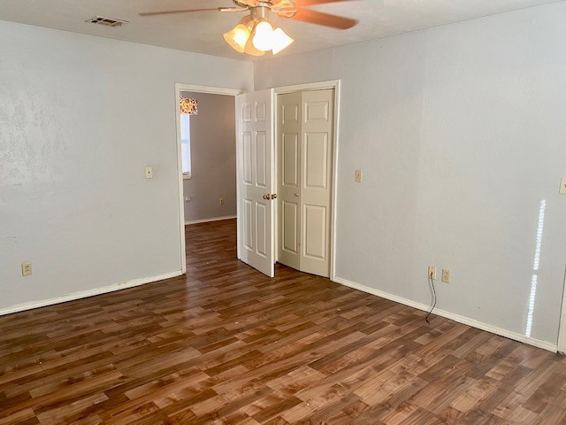 833 S Ellison Avenue, El Reno, OK 73036 unfurnished room with ceiling fan and dark hardwood / wood-style flooring