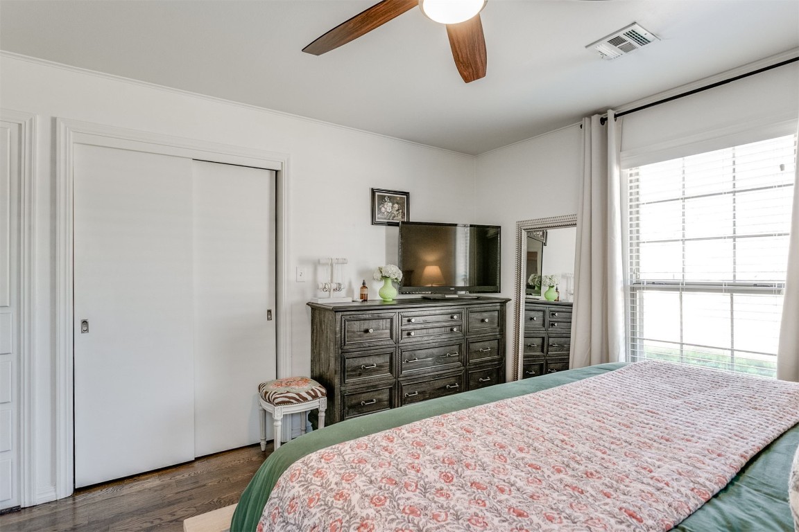 1504 Brighton Avenue, Oklahoma City, OK 73120 bedroom with a closet, ceiling fan, and dark wood-type flooring