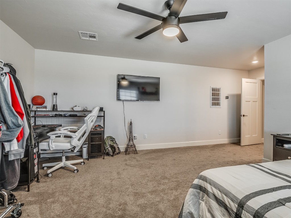 901 Jacobs Way, Yukon, OK 73099 bedroom featuring light carpet and ceiling fan