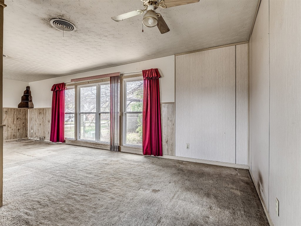 4805 N Hamilton Drive, Oklahoma City, OK 73112 carpeted empty room featuring a textured ceiling and ceiling fan