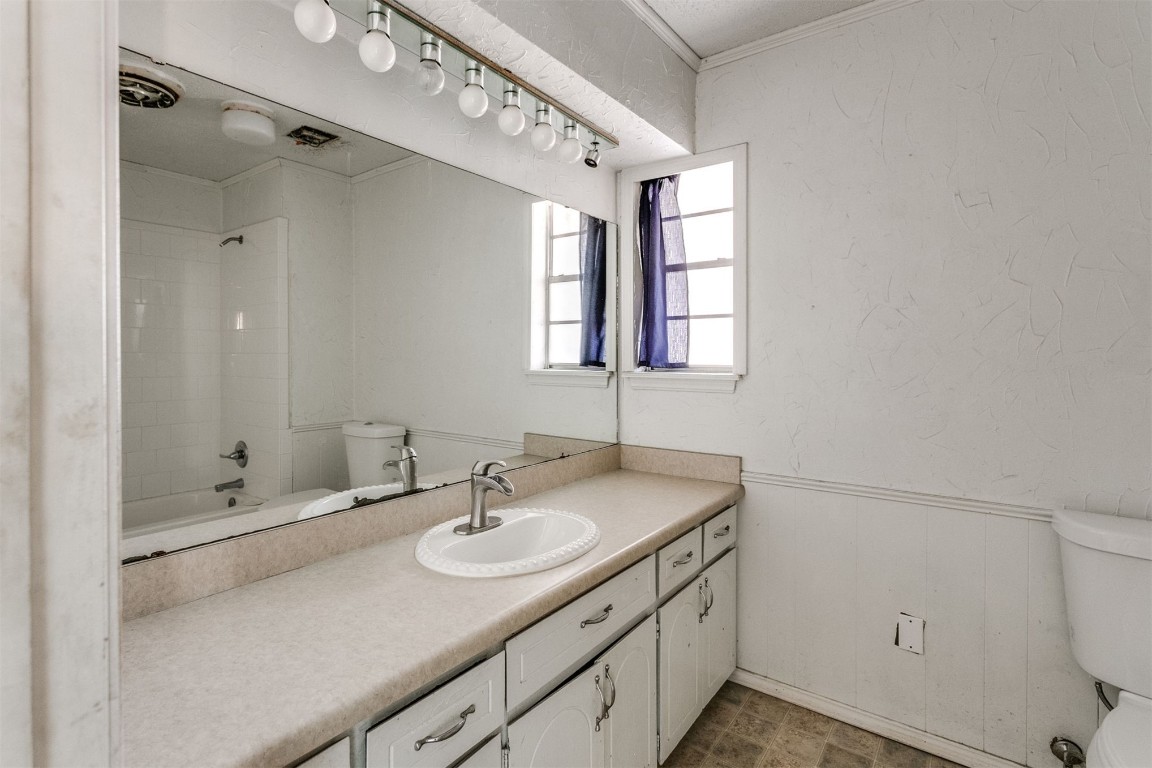 5504 NW 67th Street, Warr Acres, OK 73132 full bathroom with tile flooring, bathing tub / shower combination, vanity, and toilet