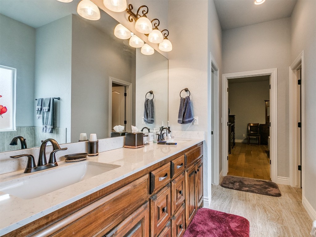 11004 Milford Lane, Oklahoma City, OK 73122 bathroom featuring oversized vanity, double sink, and tile flooring