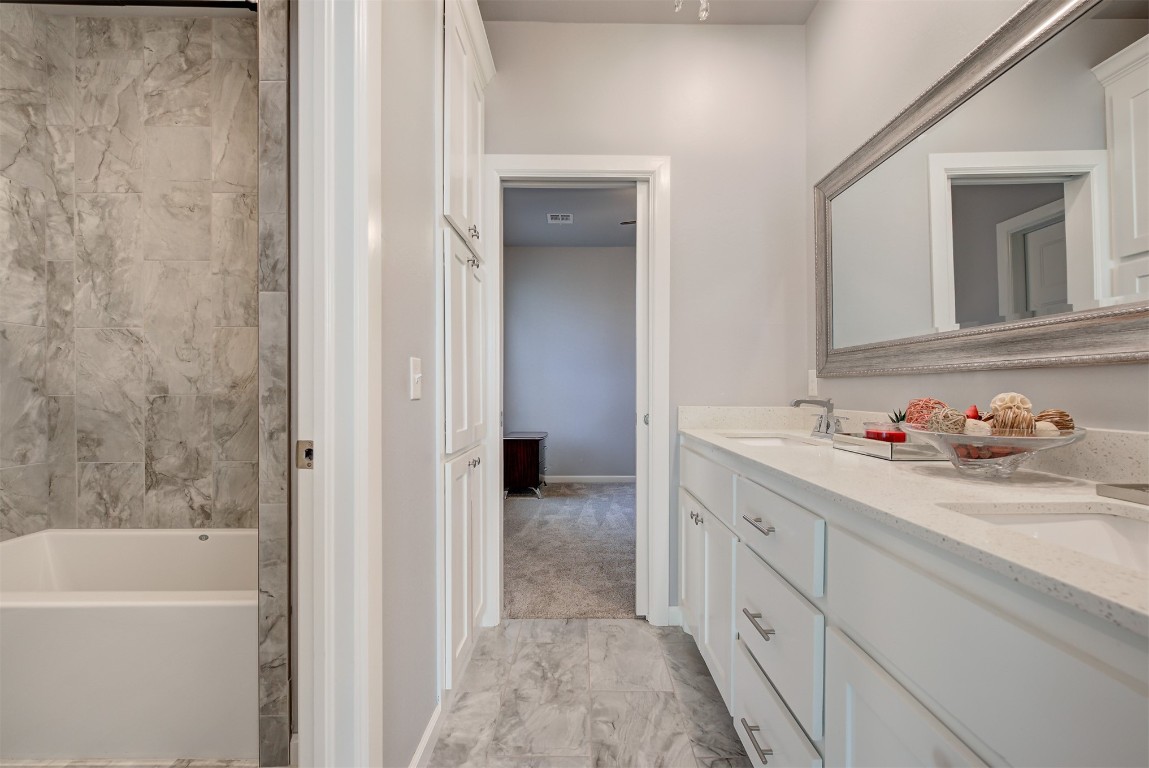 3313 SW 126th Street, Oklahoma City, OK 73170 bathroom featuring dual bowl vanity and tile flooring