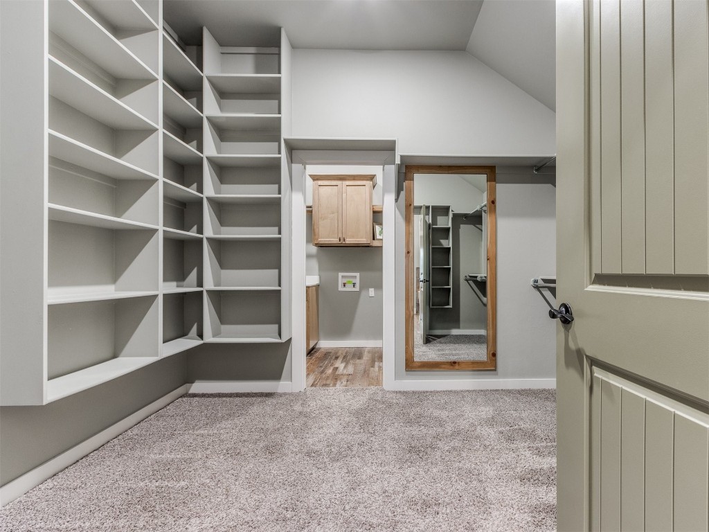 4832 Bermuda Drive, Mustang, OK 73064 walk in closet with vaulted ceiling and light carpet