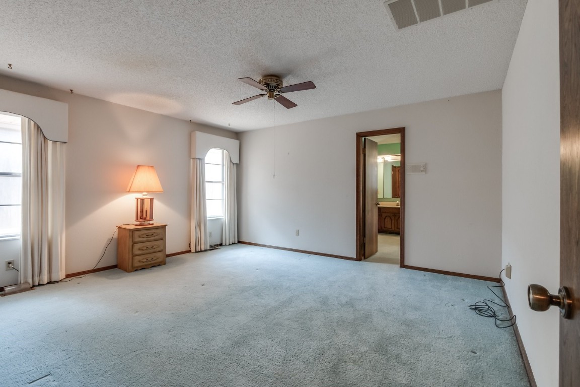 7201 Warriner Way, Oklahoma City, OK 73162 carpeted empty room featuring ceiling fan and a textured ceiling
