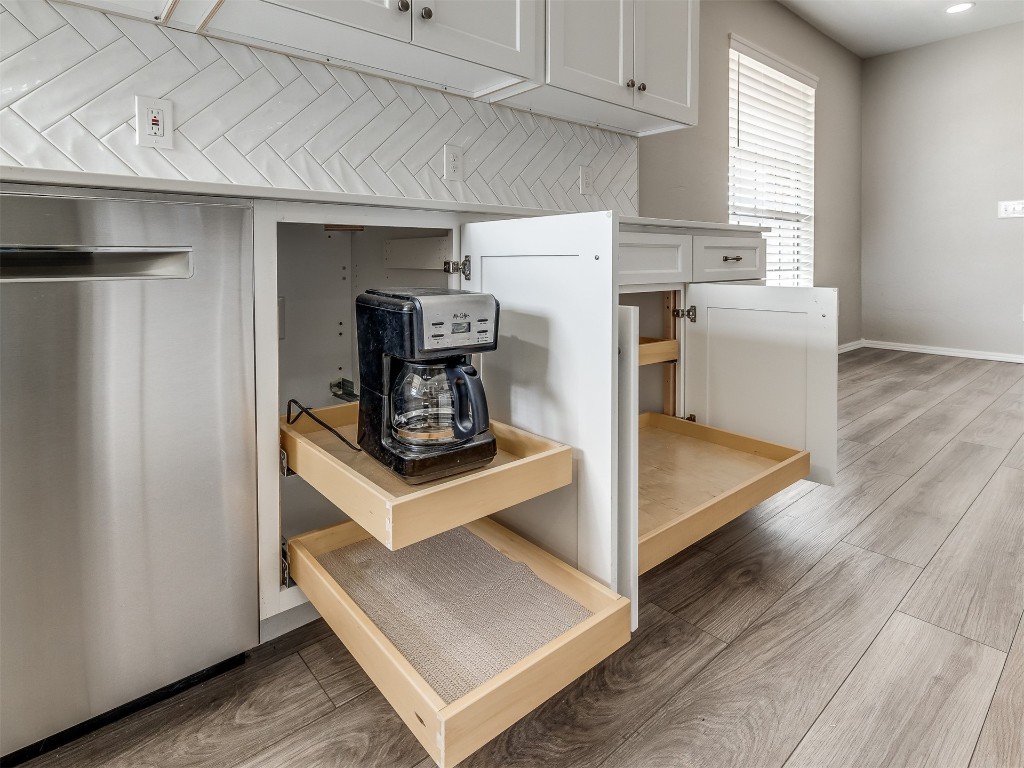 11313 Bluff Creek Drive, Oklahoma City, OK 73162 kitchen featuring white cabinets, backsplash, and wood-type flooring