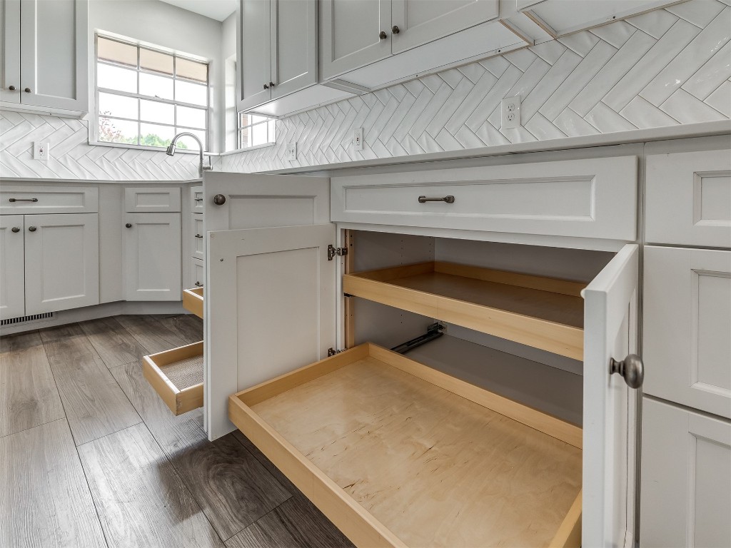 11313 Bluff Creek Drive, Oklahoma City, OK 73162 kitchen with white cabinets, backsplash, and dark hardwood / wood-style flooring