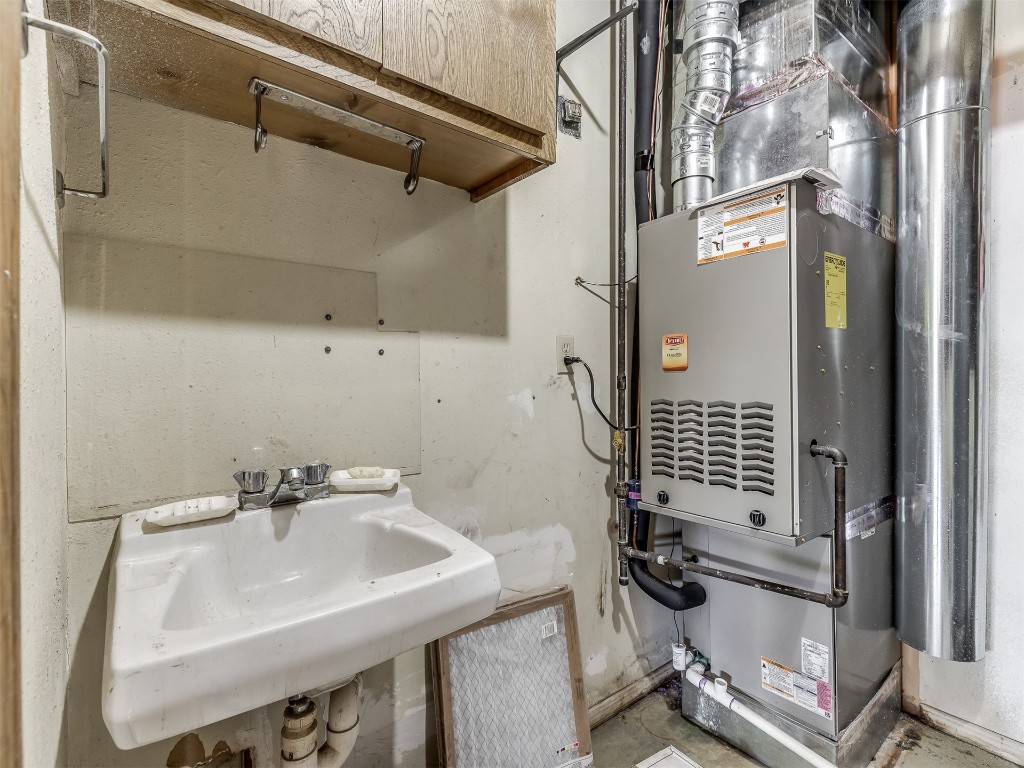 11313 Bluff Creek Drive, Oklahoma City, OK 73162 bathroom featuring concrete floors and sink