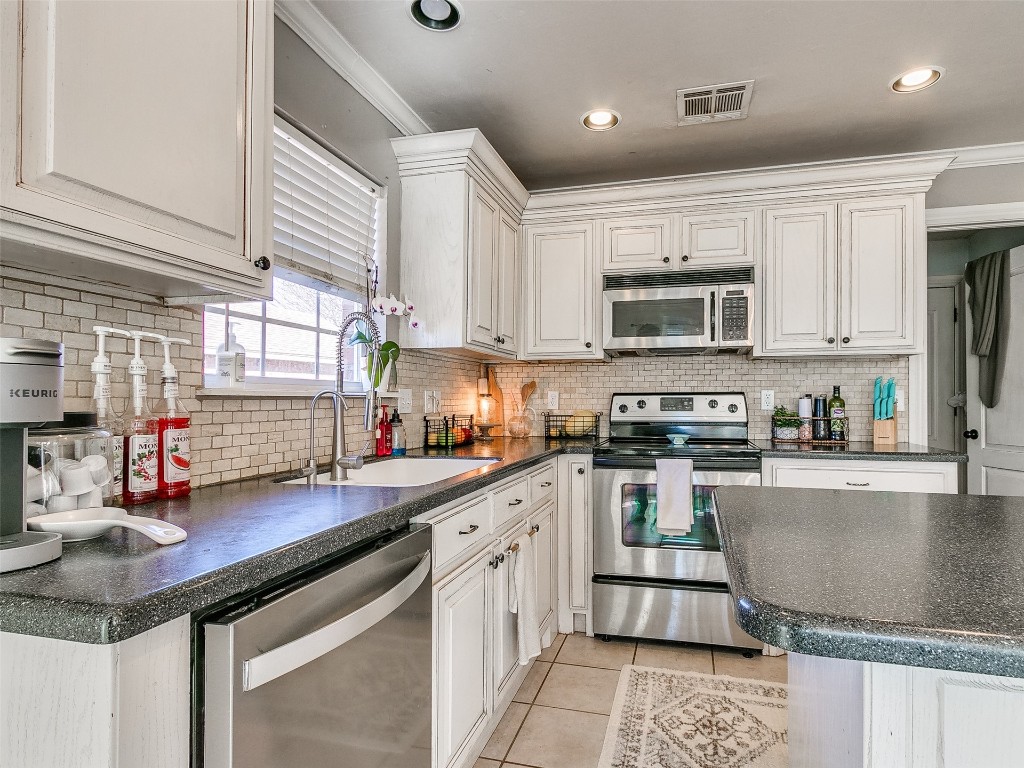 4605 Elk Creek Drive, Yukon, OK 73099 kitchen featuring white cabinets and appliances with stainless steel finishes