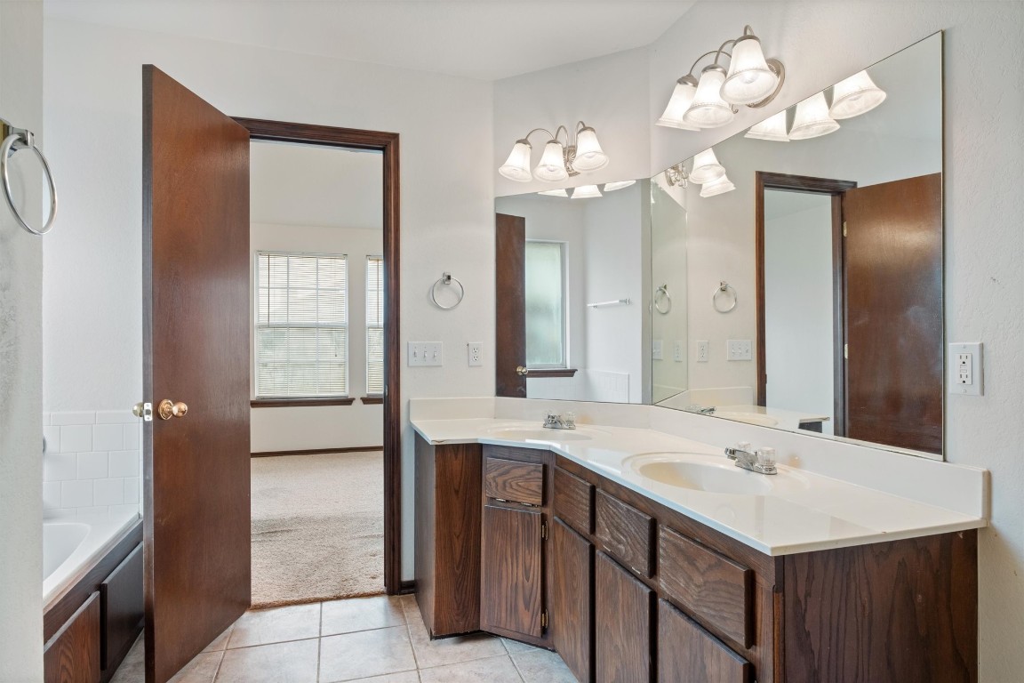 12512 SW 13th Street, Yukon, OK 73099 bathroom with double sink, tile flooring, and large vanity