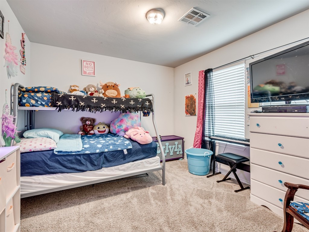 11016 NW 99th Street, Yukon, OK 73099 bedroom with light carpet
