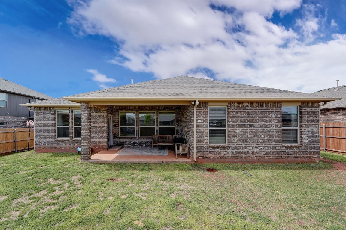 3508 Molly Drive, Yukon, OK 73099 back of property featuring a patio area and a lawn