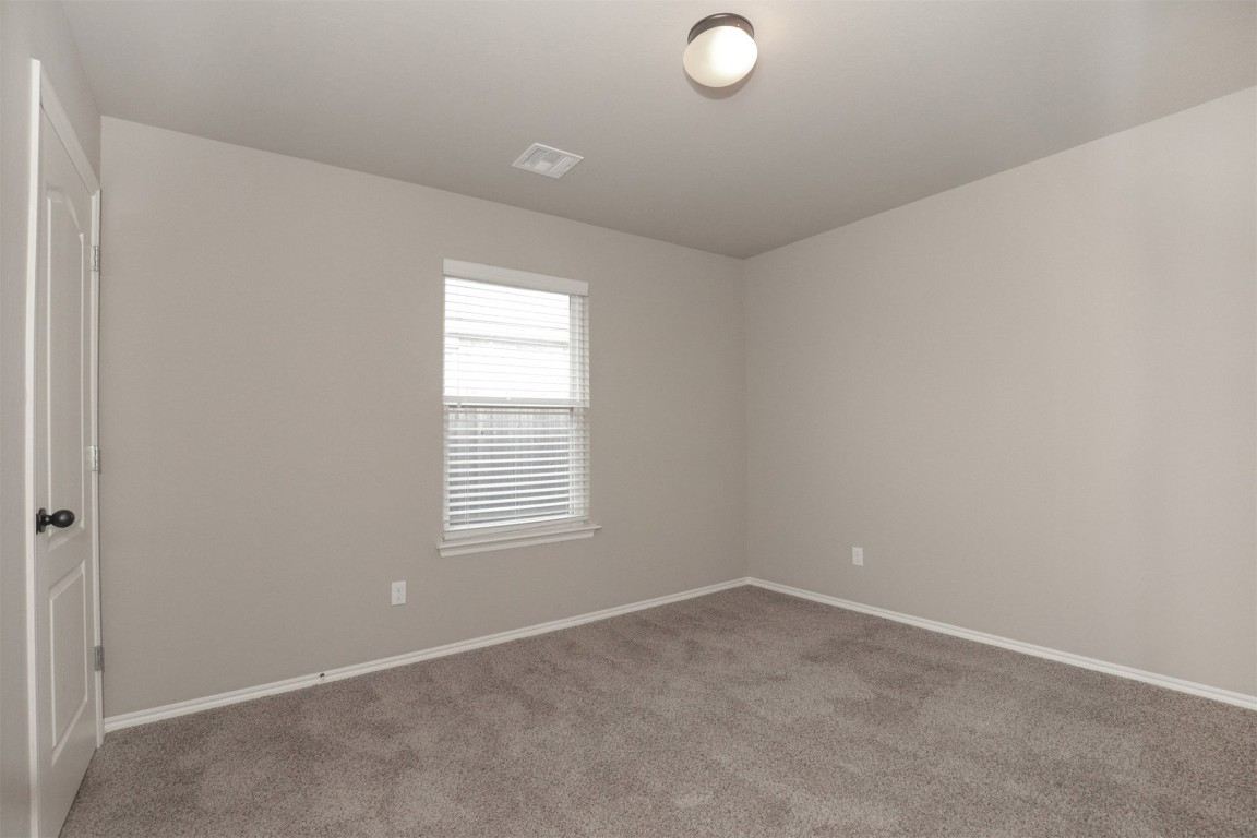 8417 SW 48th Street, Oklahoma City, OK 73179 spare room with light colored carpet