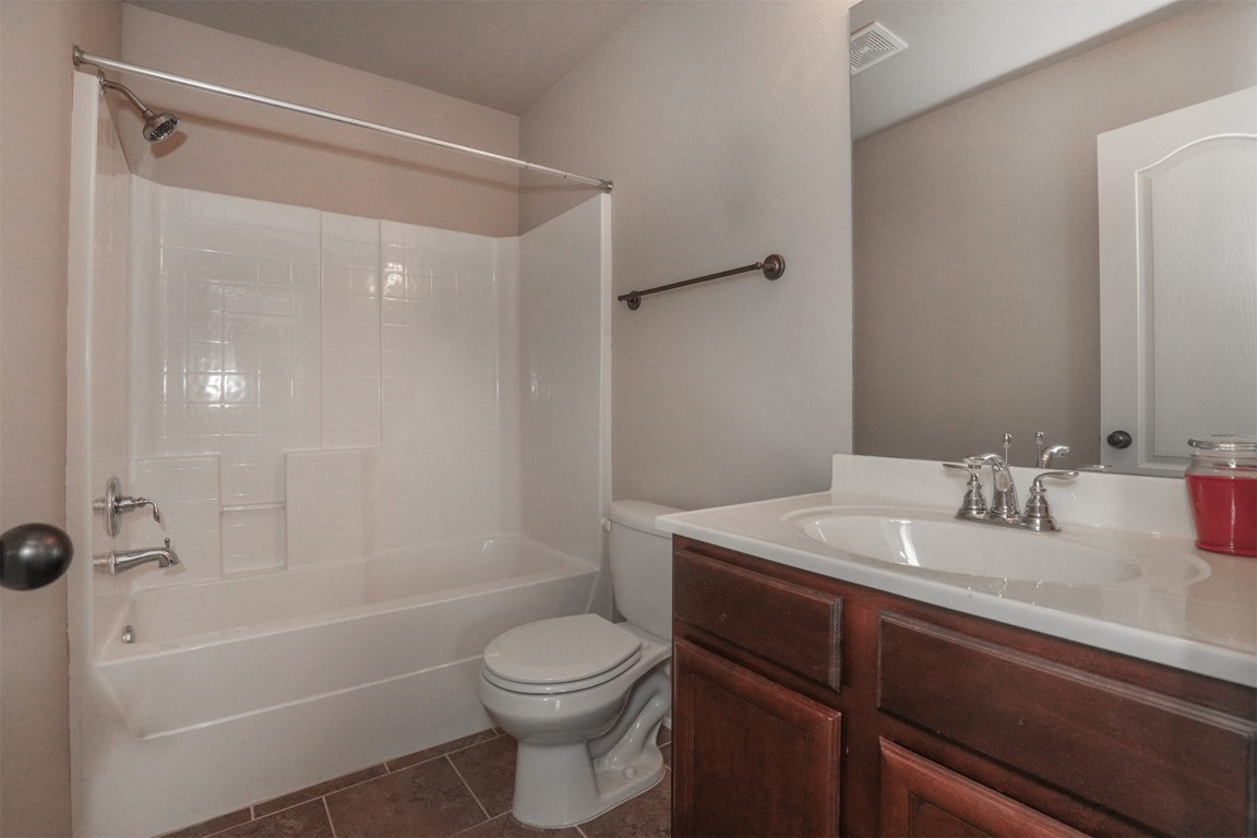 8417 SW 48th Street, Oklahoma City, OK 73179 full bathroom with toilet, bathtub / shower combination, tile flooring, and vanity