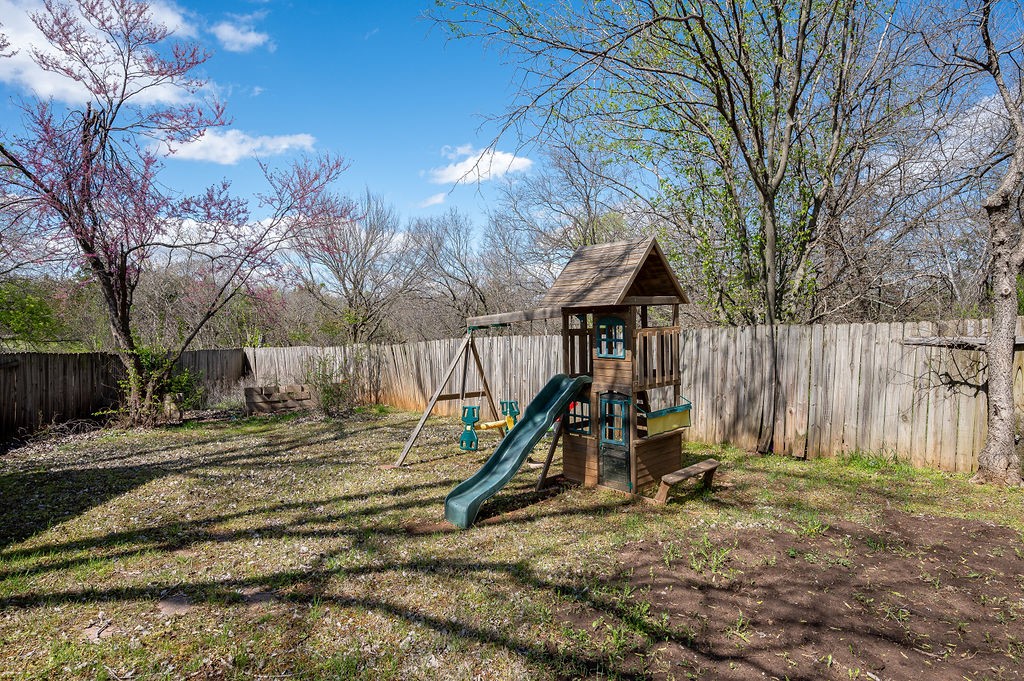 1701 Baron Drive, Norman, OK 73071 view of jungle gym featuring a lawn