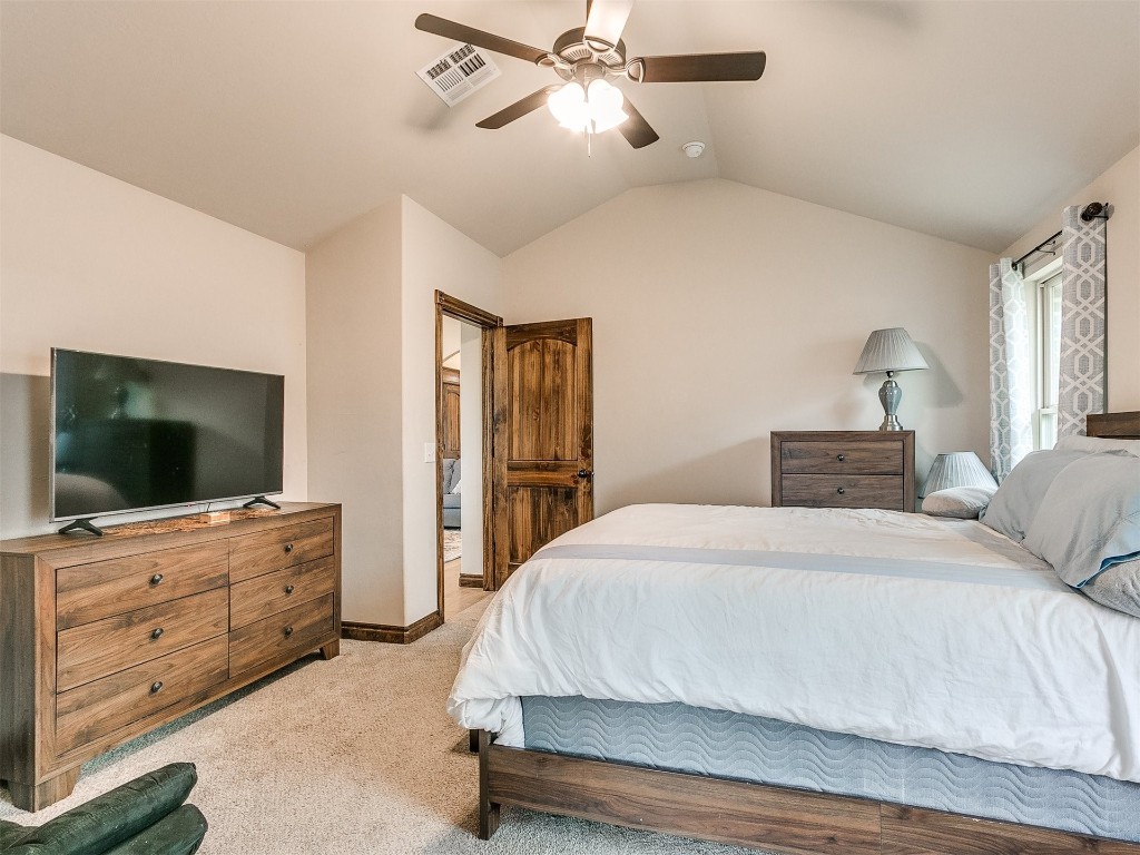 215 Tuscany Circle, Noble, OK 73068 carpeted bedroom featuring ceiling fan and lofted ceiling