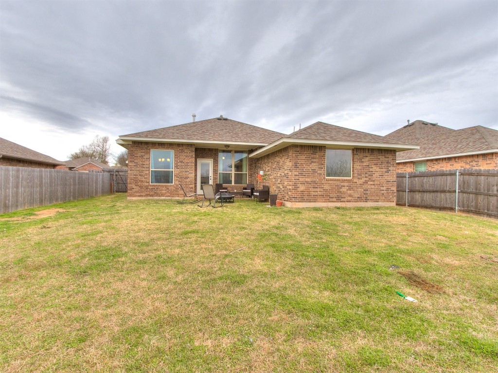 215 Tuscany Circle, Noble, OK 73068 back of house with a lawn and a patio