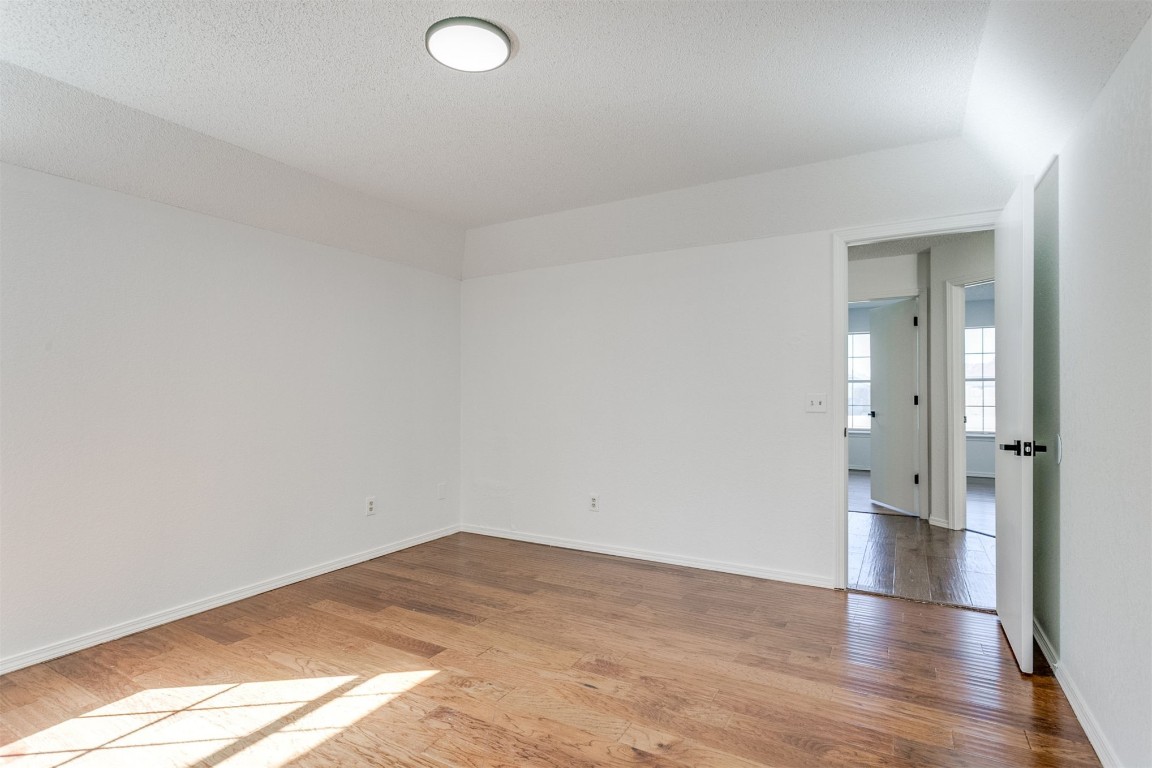 15124 Todd Way, Oklahoma City, OK 73170 empty room with a textured ceiling and light hardwood / wood-style flooring