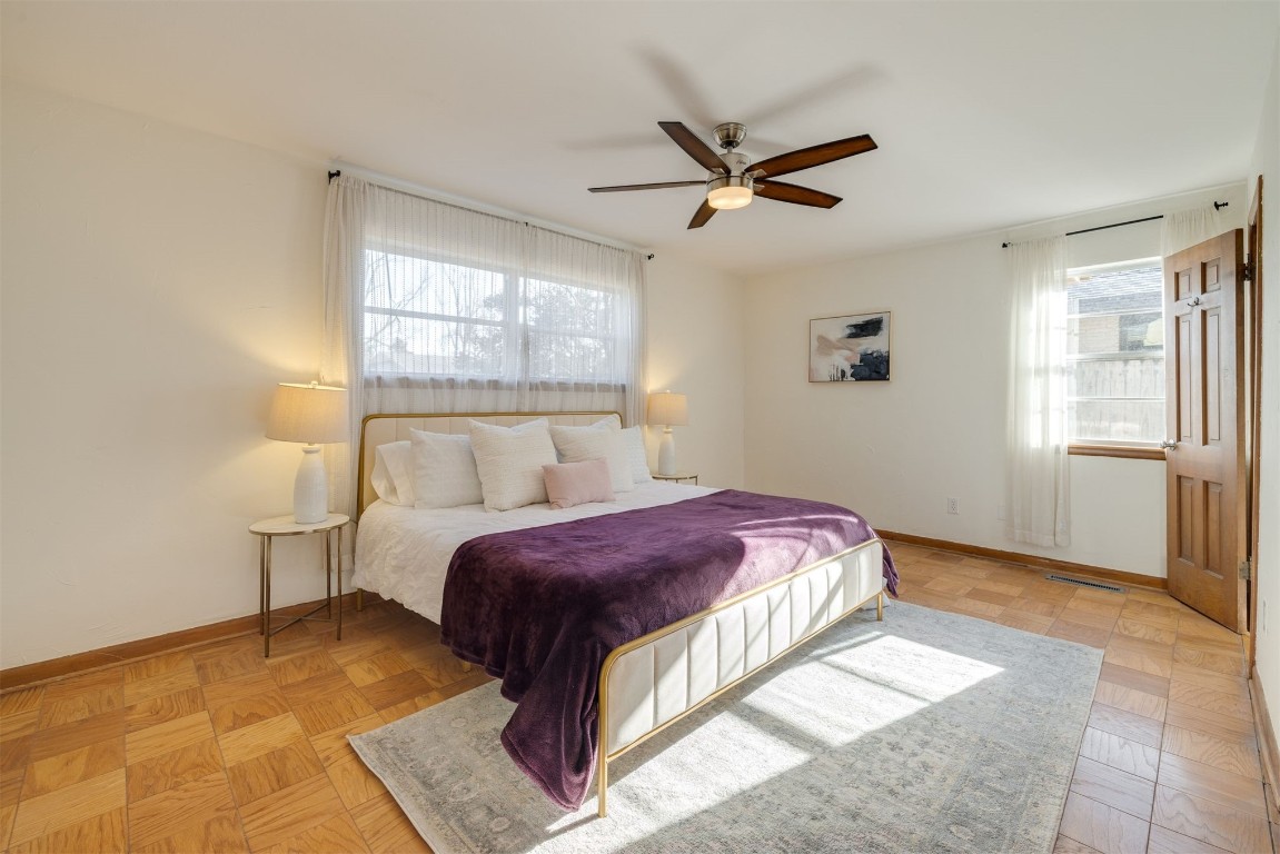 2612 Berkshire Way, Oklahoma City, OK 73120 bedroom featuring light parquet flooring, ceiling fan, and multiple windows