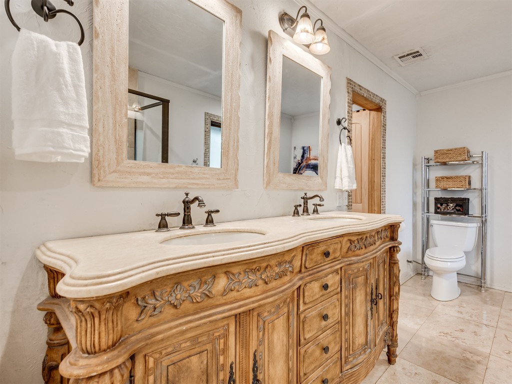 6313 Chatham Road, Oklahoma City, OK 73132 bathroom featuring double sink vanity, toilet, ornamental molding, and tile floors