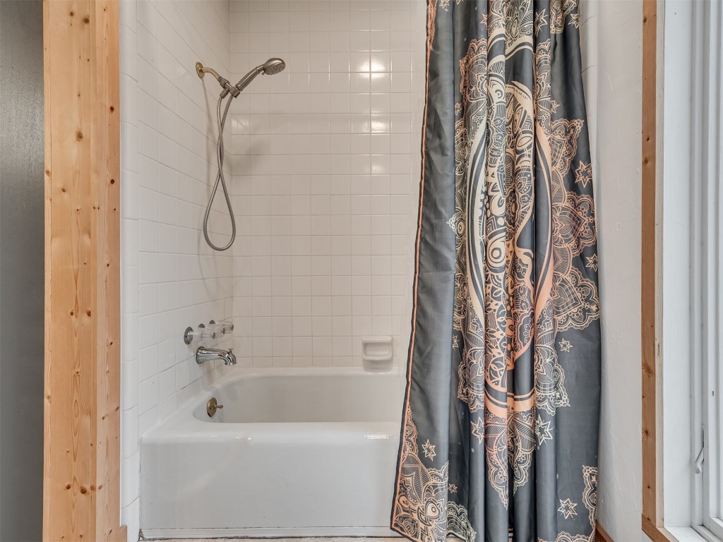 6313 Chatham Road, Oklahoma City, OK 73132 bathroom with shower / bathtub combination with curtain