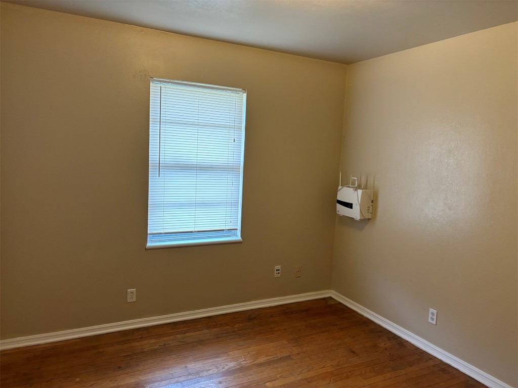 1125 NW 88th Street, Oklahoma City, OK 73114 unfurnished room featuring dark wood-type flooring