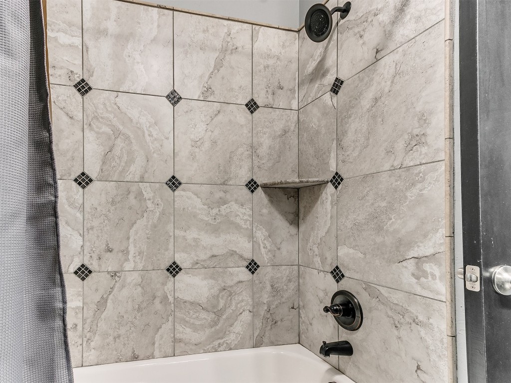 18212 Bridlington Drive, Edmond, OK 73012 room details with shower / tub combo with curtain