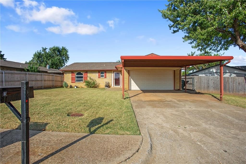 814 Cherrywood Lane, Yukon, OK 73099 ranch-style home with a front yard and a garage