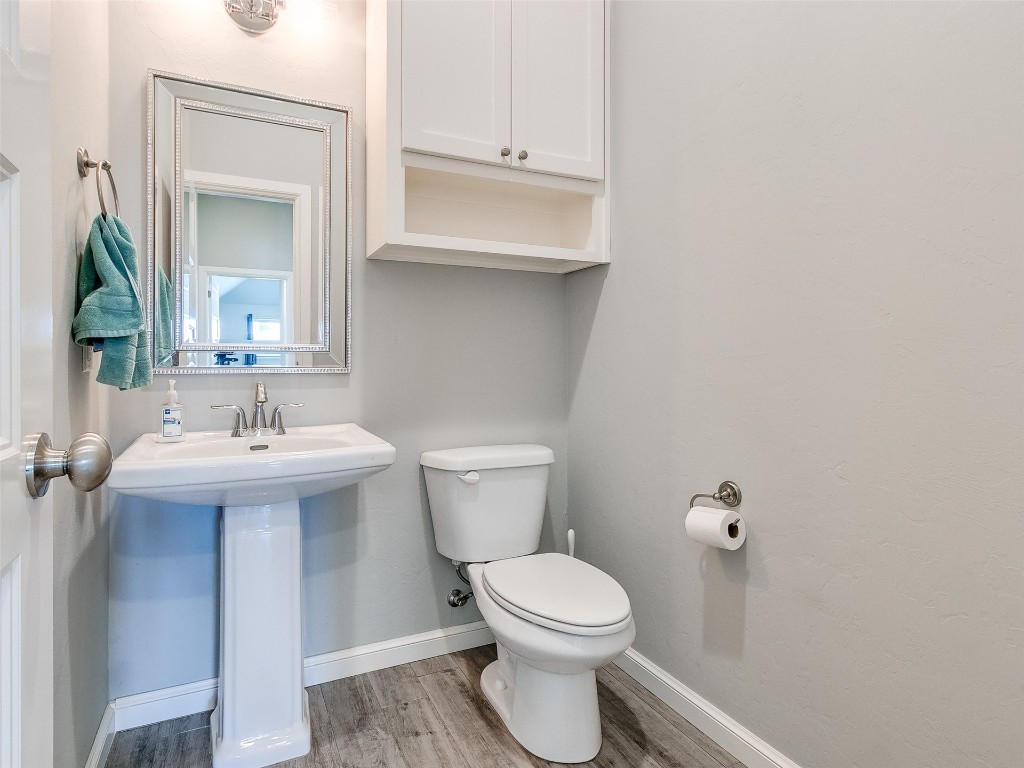 4325 SW 129th Street, Oklahoma City, OK 73173 bathroom featuring hardwood / wood-style floors, toilet, and sink