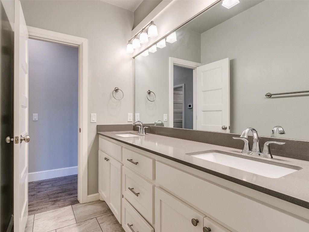 4325 SW 129th Street, Oklahoma City, OK 73173 bathroom with dual vanity and hardwood / wood-style floors
