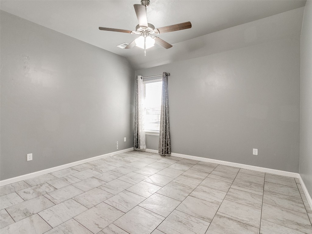 4325 SW 129th Street, Oklahoma City, OK 73173 spare room featuring light tile flooring and ceiling fan