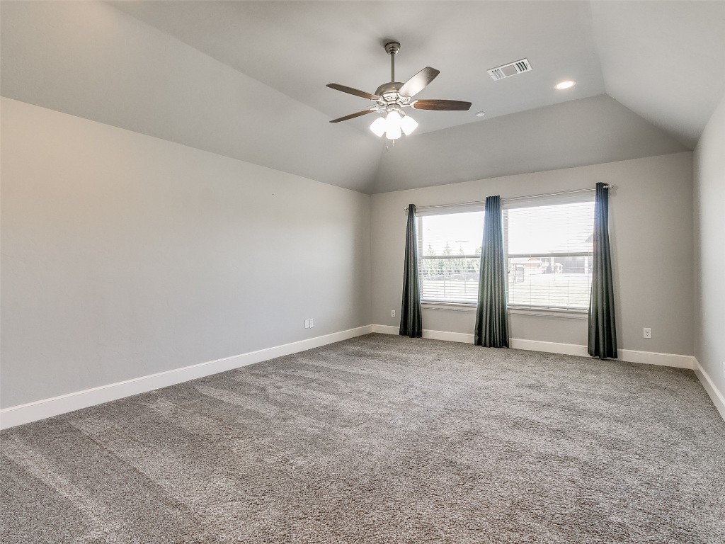 4325 SW 129th Street, Oklahoma City, OK 73173 carpeted spare room featuring ceiling fan and vaulted ceiling